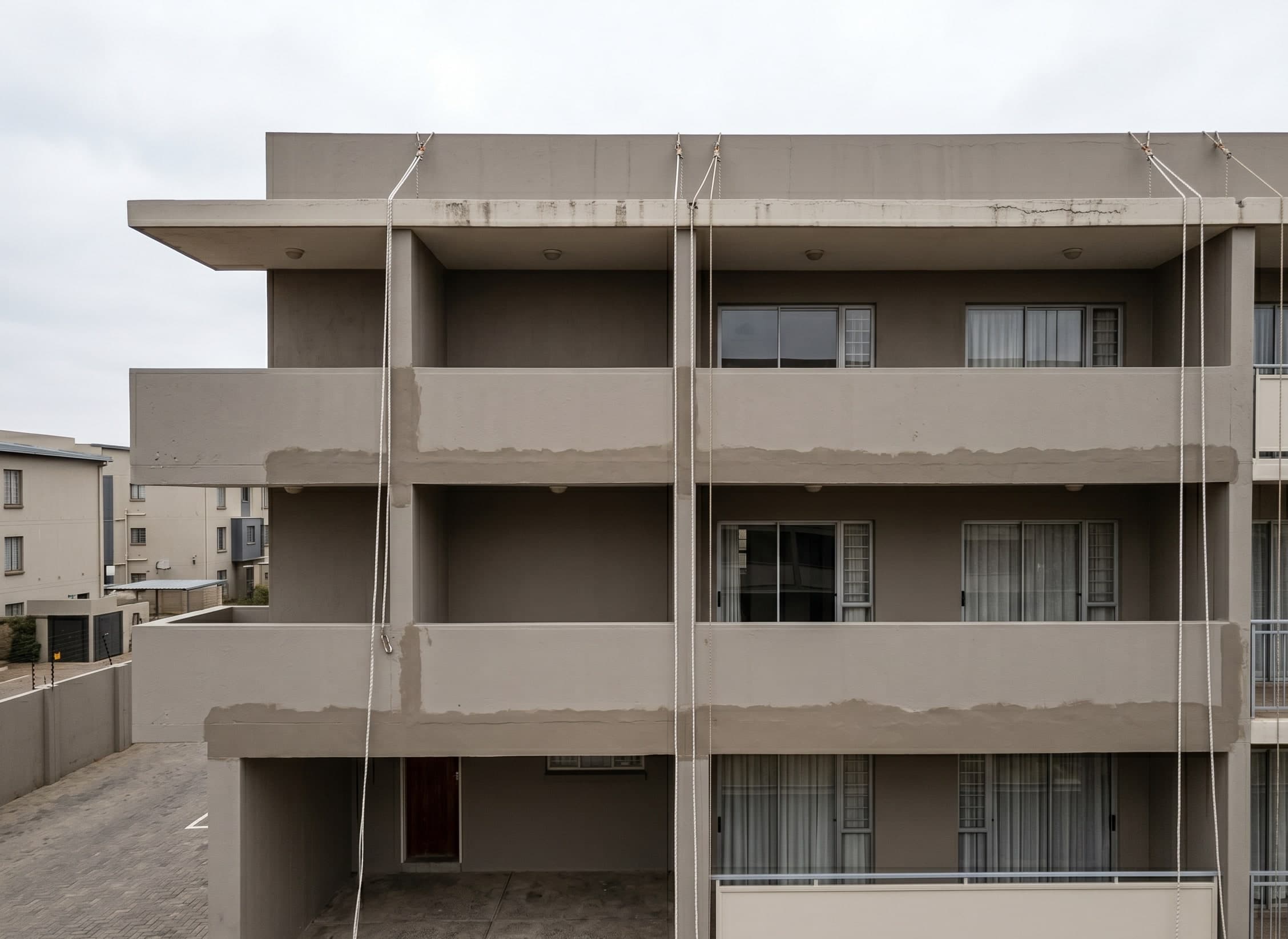 Completed rope-access façade repaint on a modest Gauteng sectional-title building