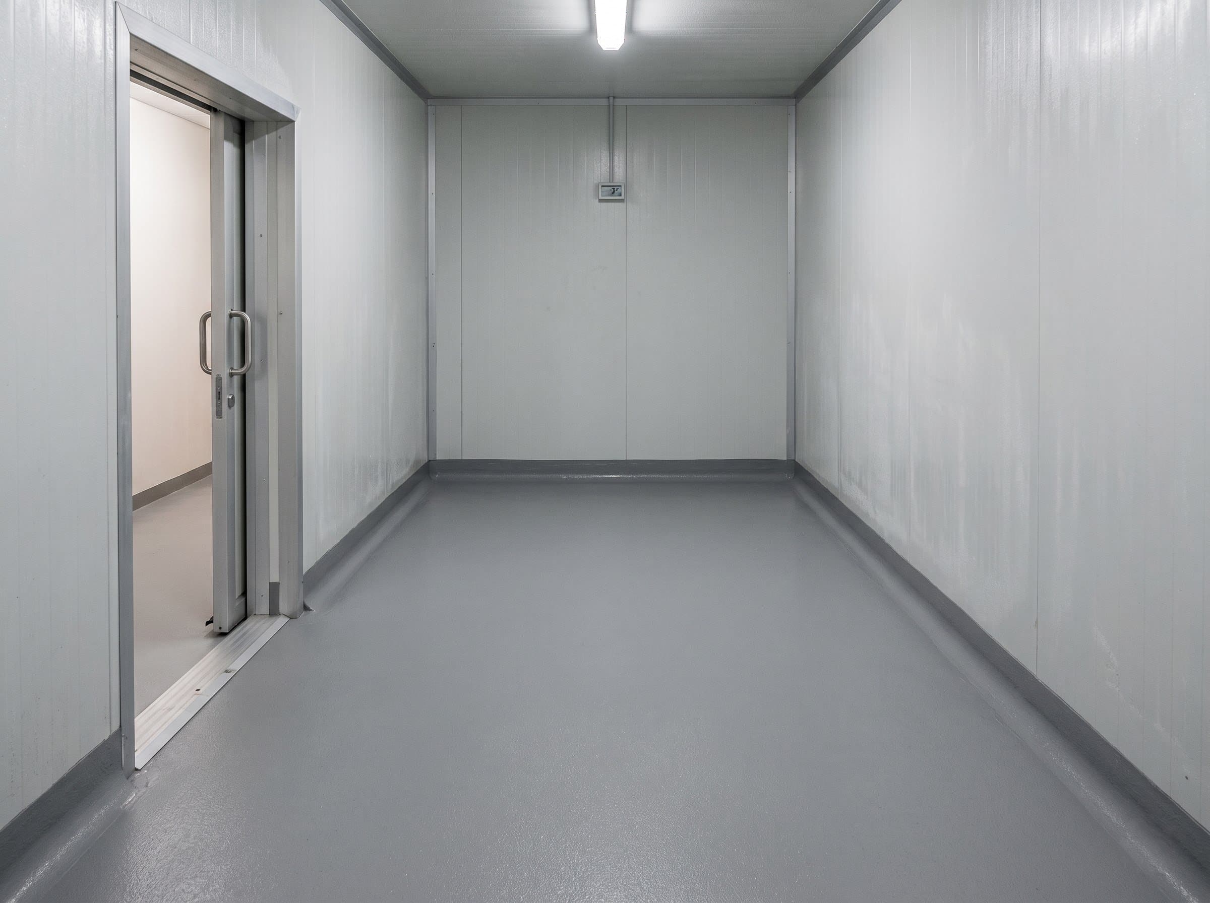 Completed cold-room epoxy or polyurethane-cement floor with coved wall base