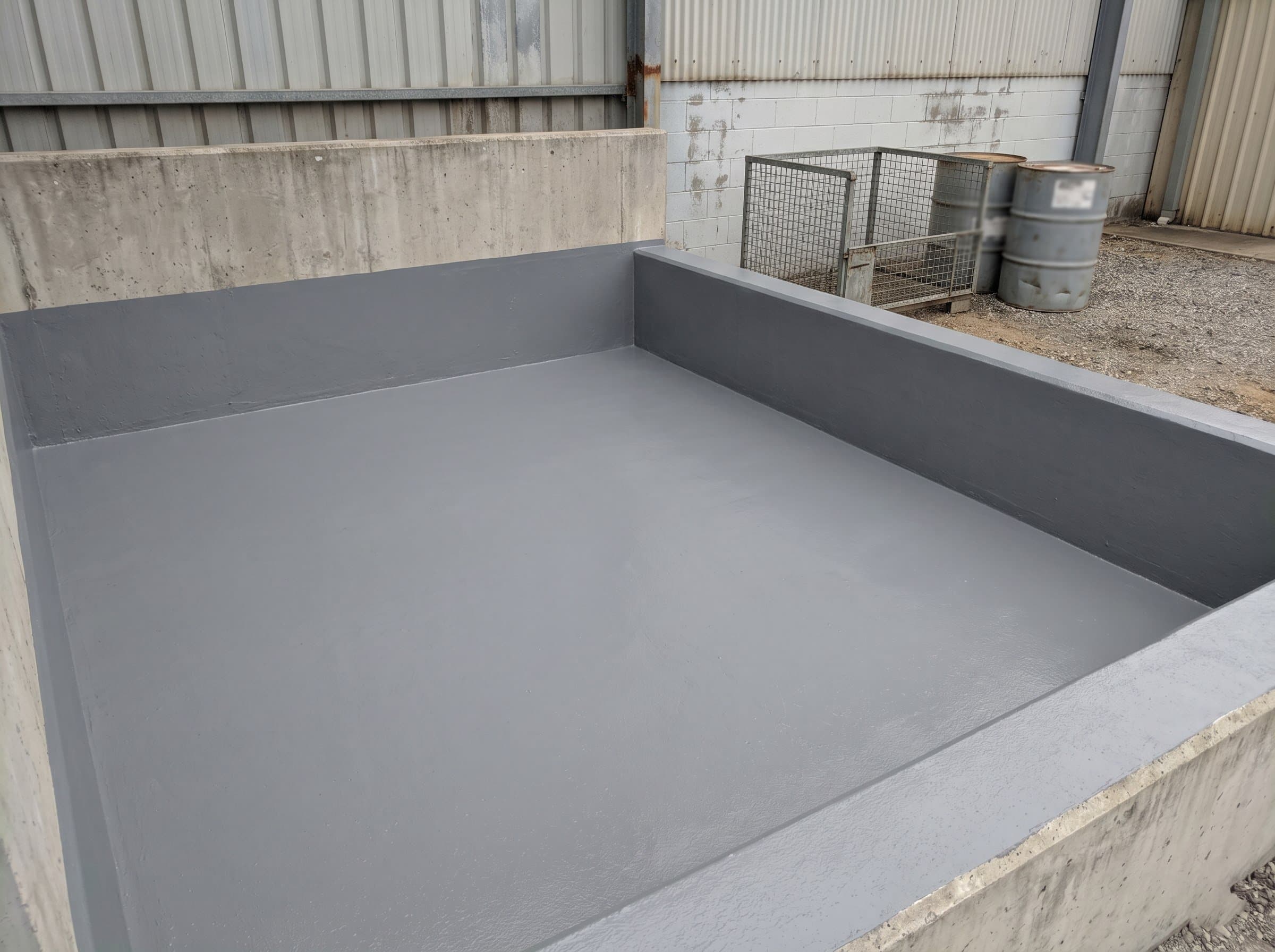 Completed epoxy lining in a small chemical storage bund