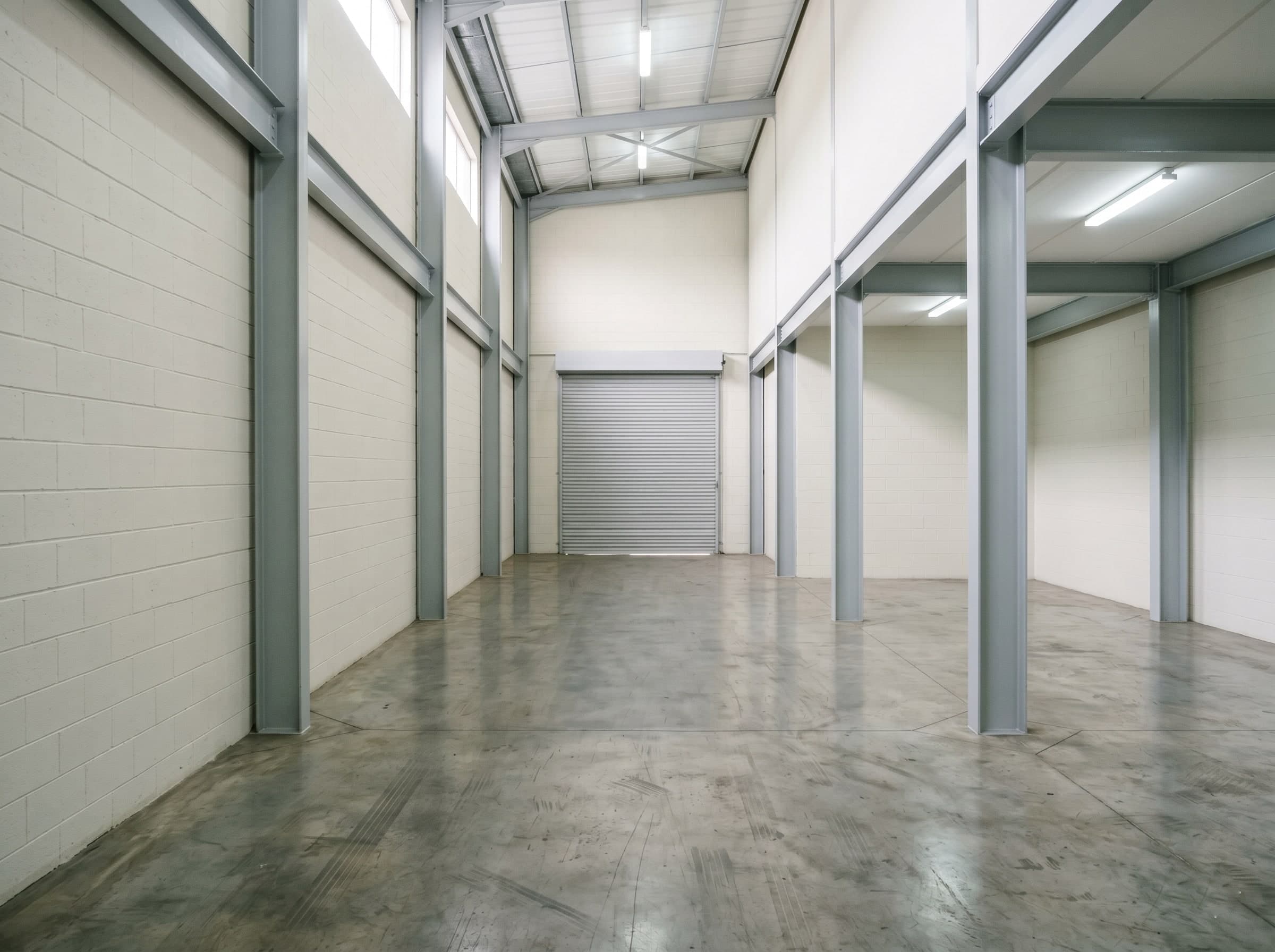 Completed logistics hall interior repaint with refreshed walls and columns in Isando