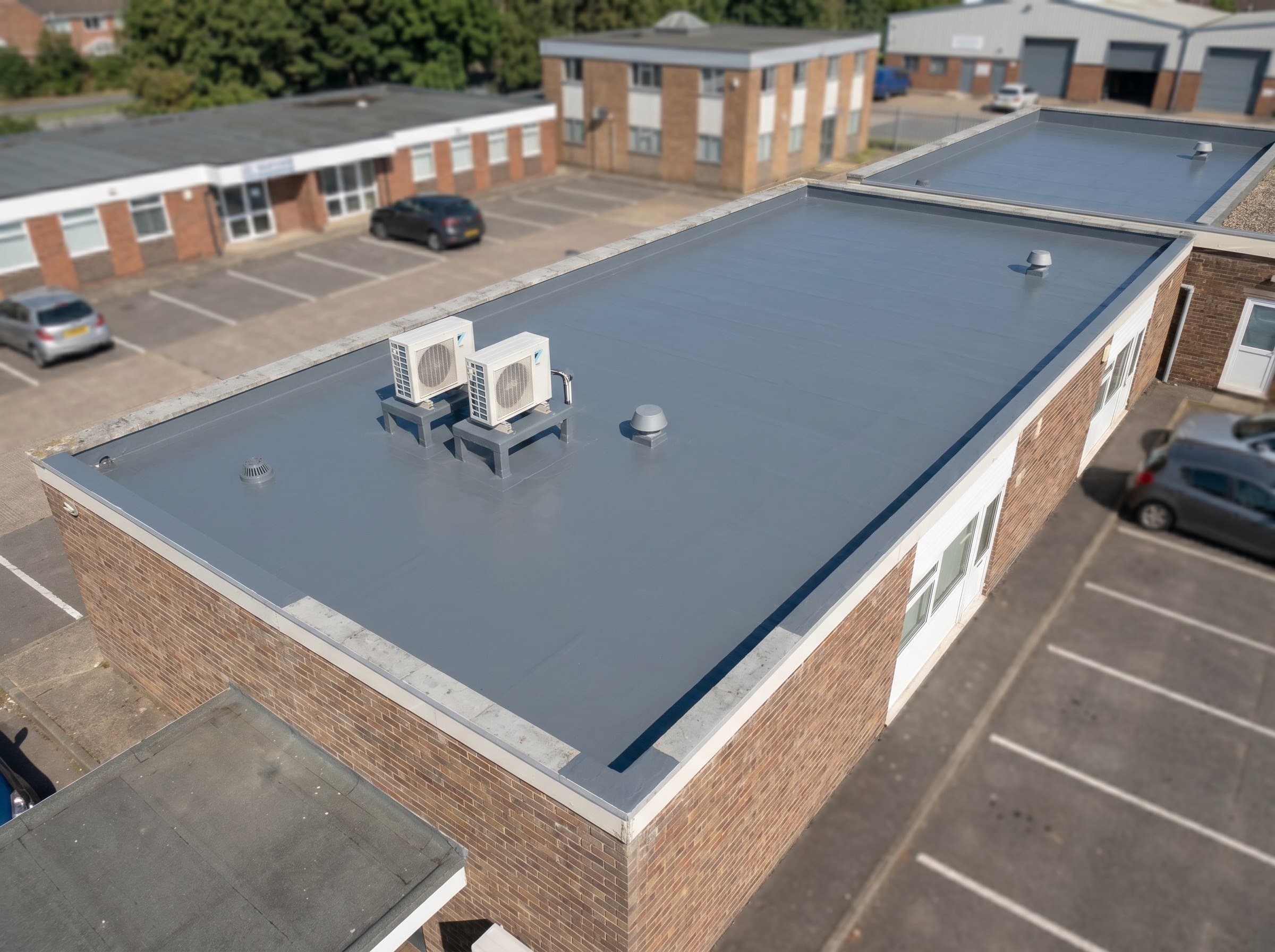 Finished flat roof with flashed AC bases on a small office strip