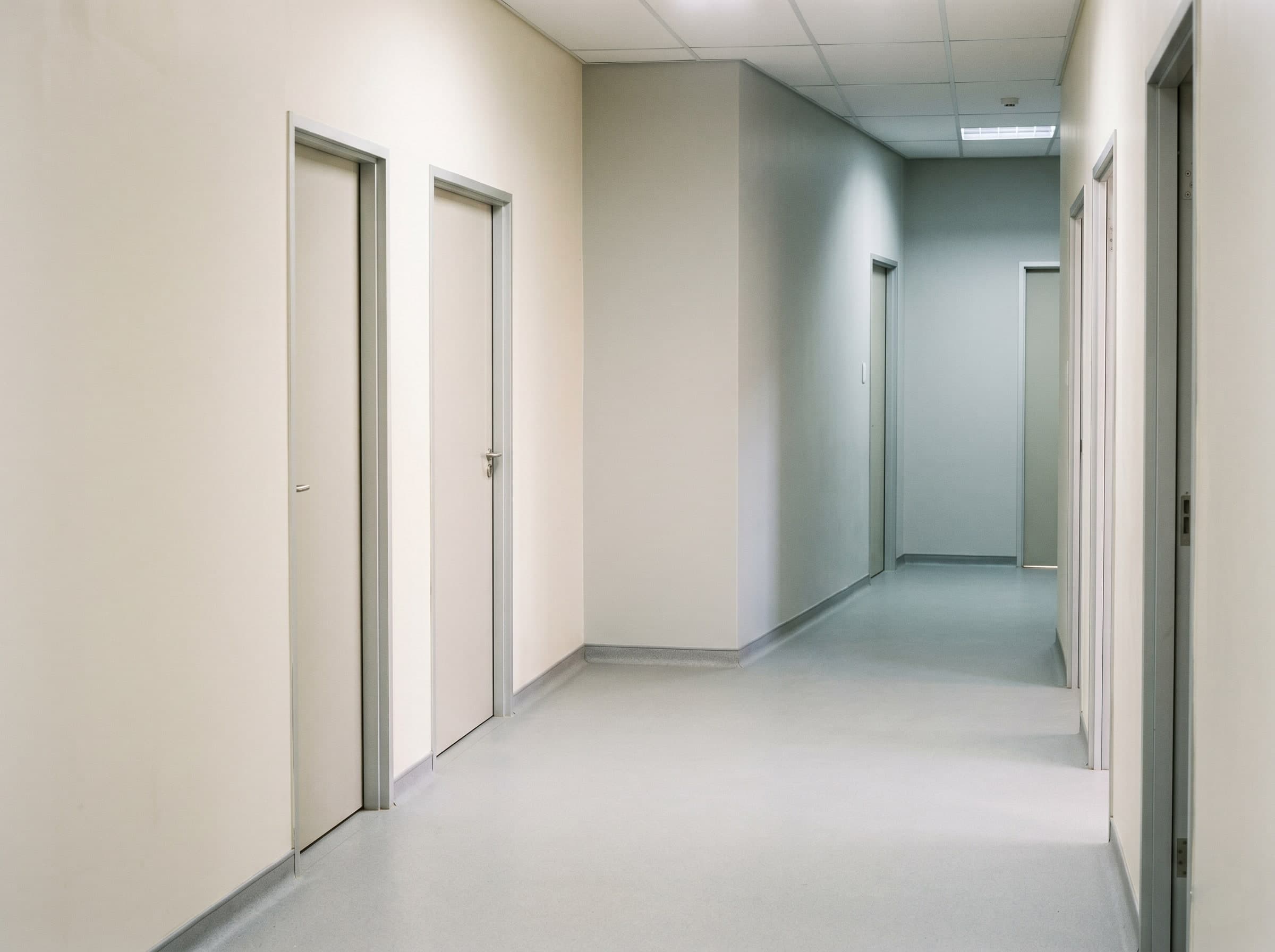 Completed ward hallway with antimicrobial wall coatings and seamless flooring in a new Gauteng hospital
