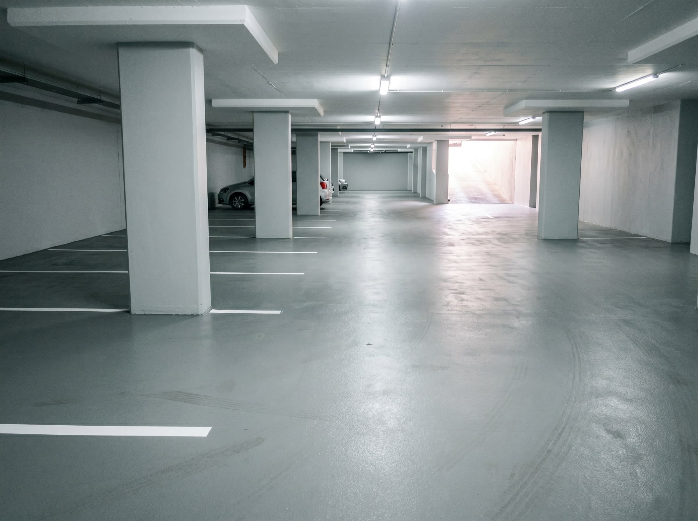 Completed light-reflective wall and deck coatings in a sectional-title basement parking level in Gauteng