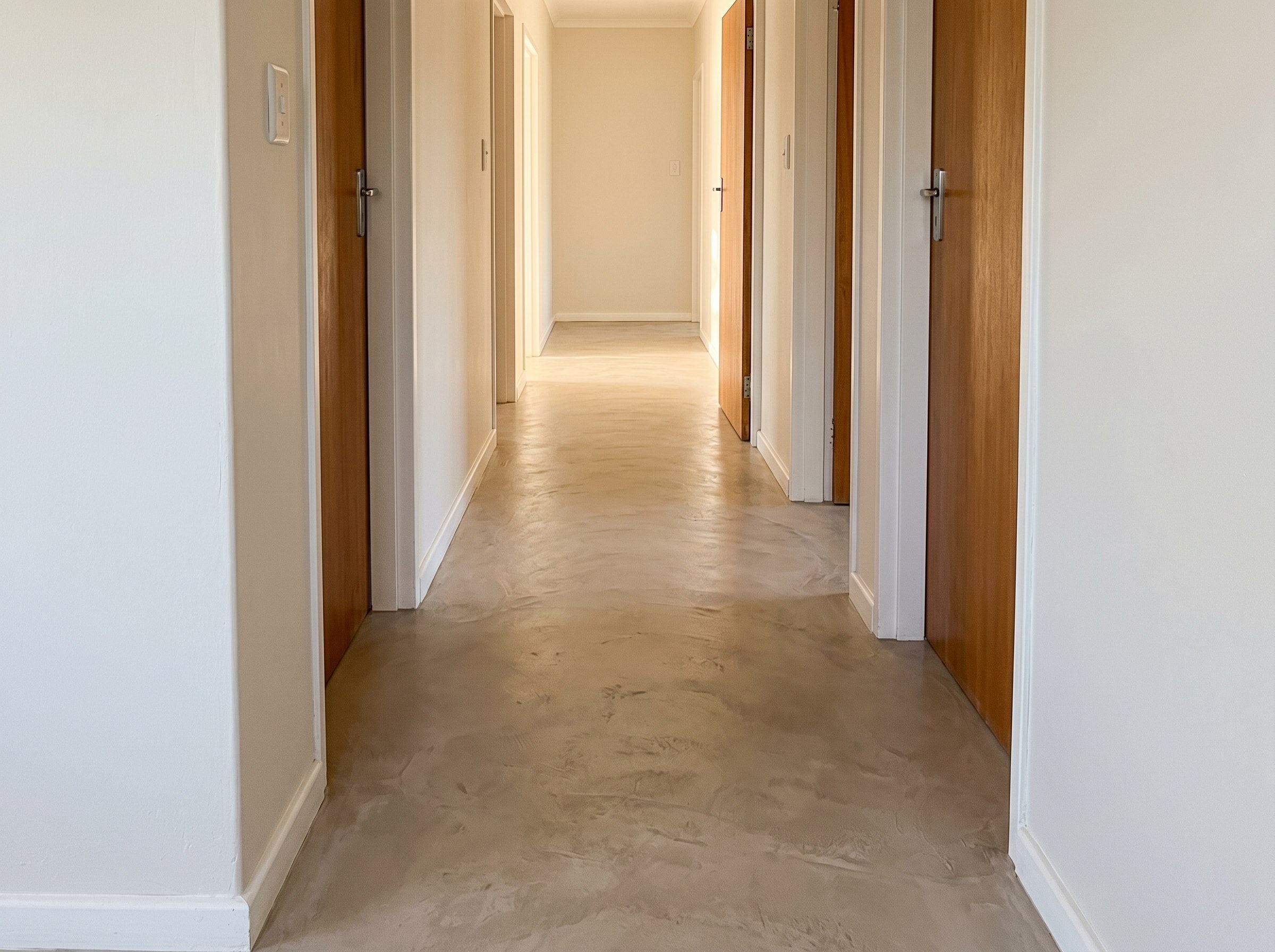 Finished cement floor in a residential hallway