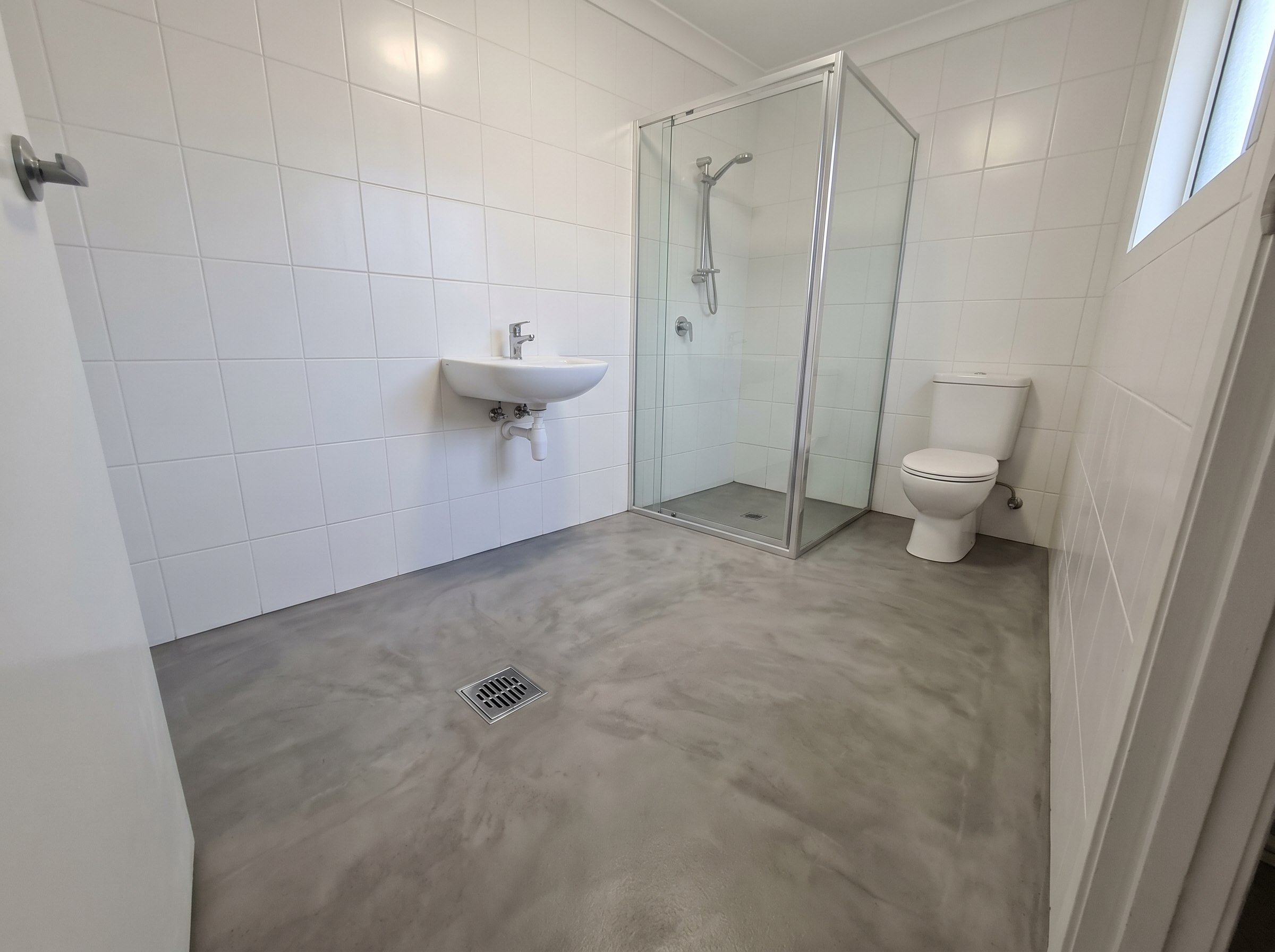 Completed sealed cement floor in a small en-suite bathroom