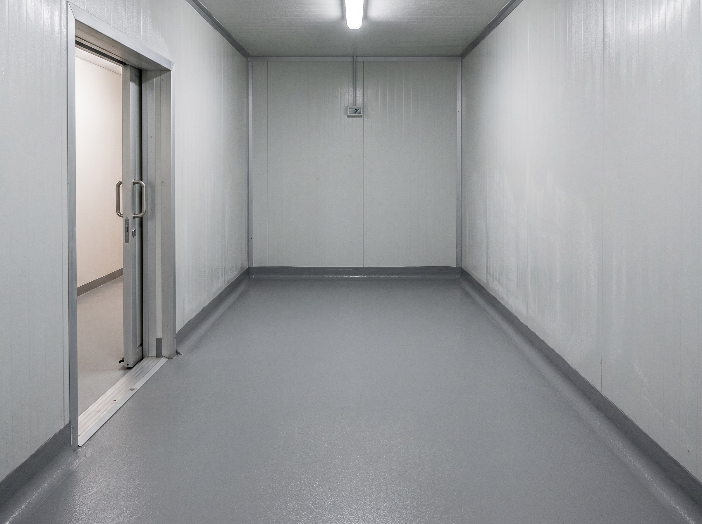Completed cold-room epoxy or polyurethane-cement floor with coved wall base