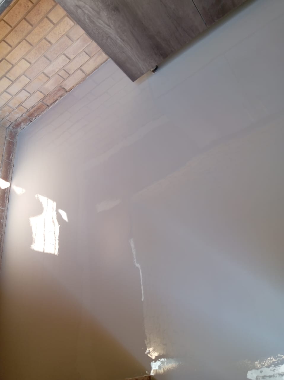 Chemical rising damp injection and salt-retardant replastering on a townhouse