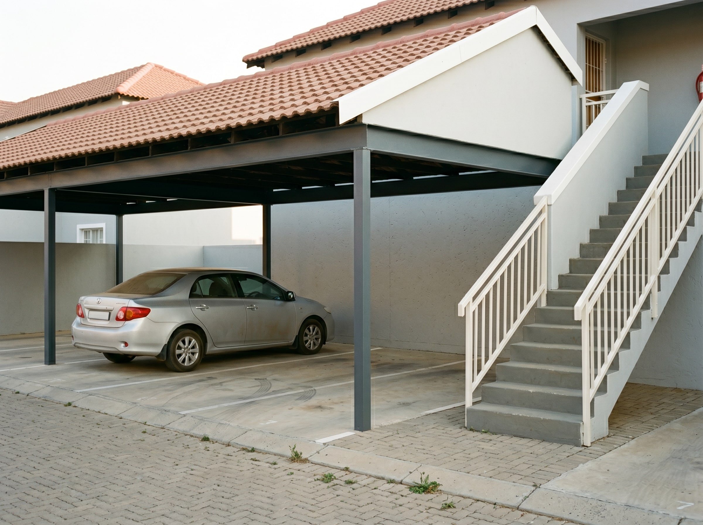 Completed common-property carport and stairwell exterior painting at a Gauteng sectional-title complex