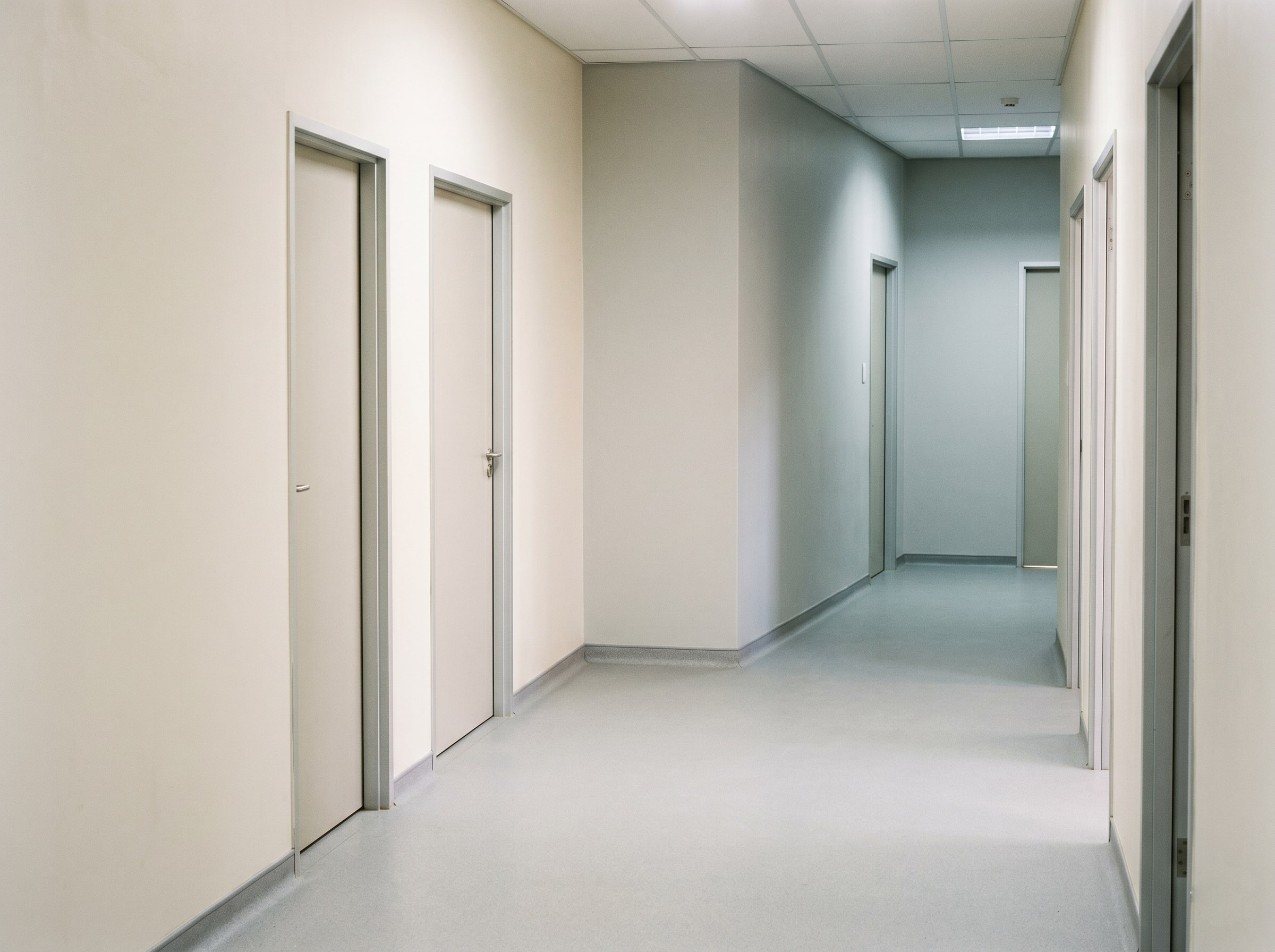 Completed ward hallway with antimicrobial wall coatings and seamless flooring in a new Gauteng hospital