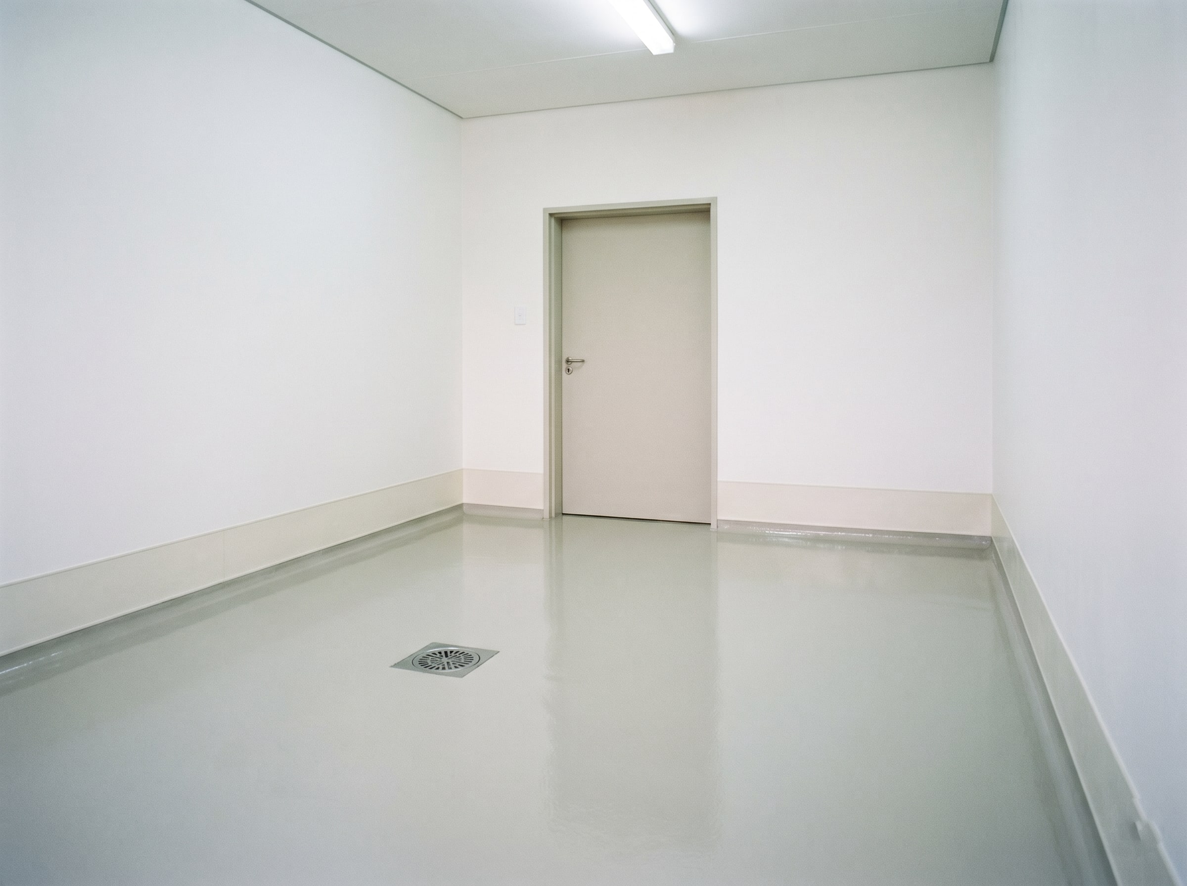 Completed hygienic coatings in an empty hospital sluice or prep room with resin floor in Gauteng