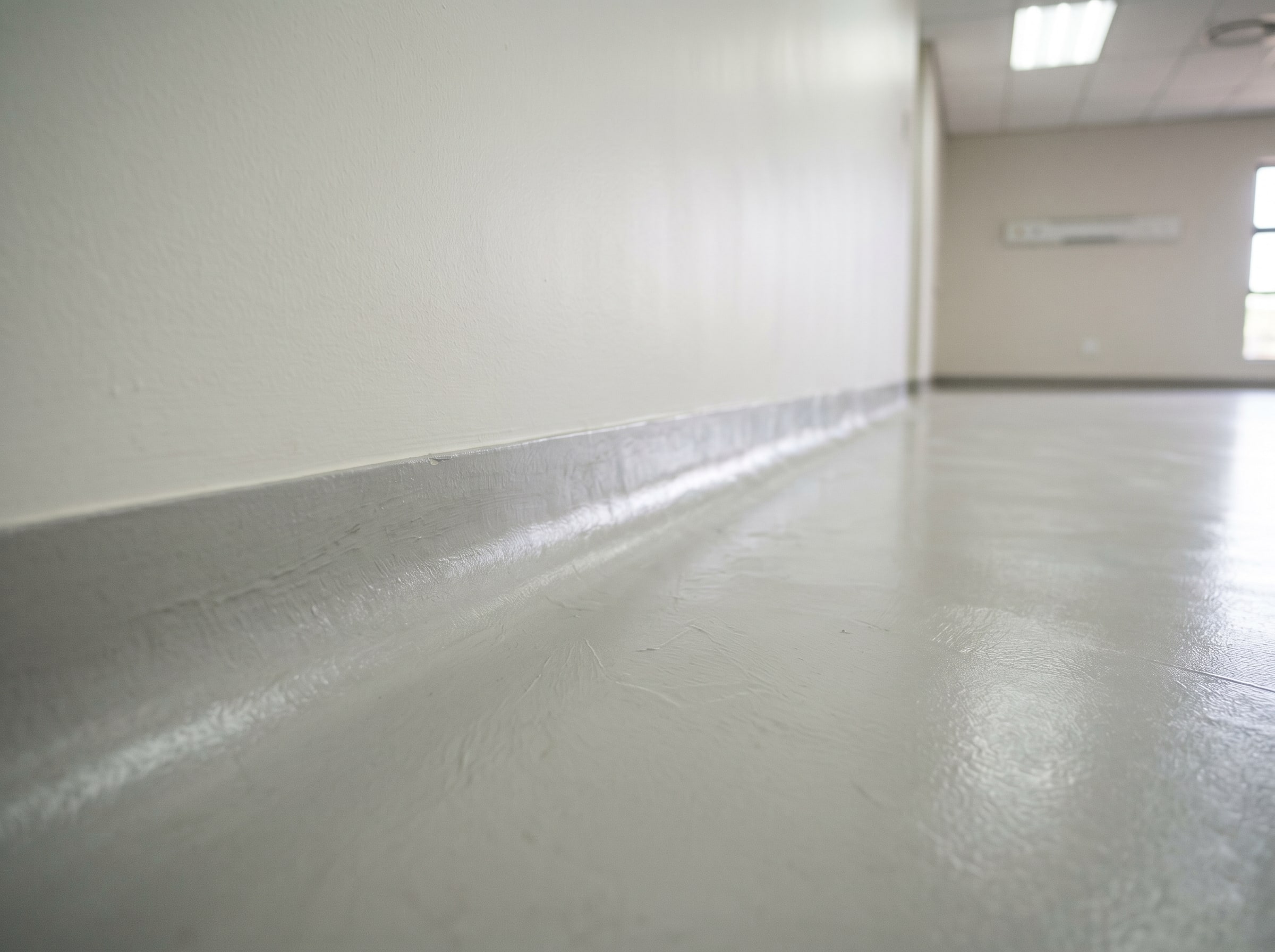 Close view of completed hospital wall paint and resin floor coving junction in Gauteng