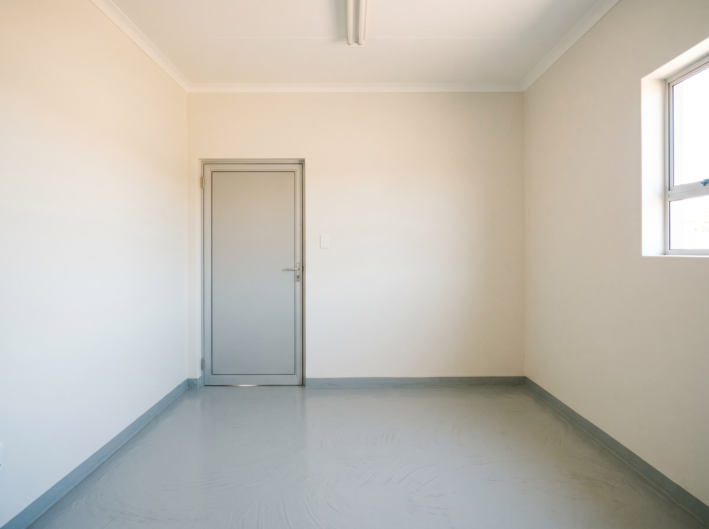 Completed low-VOC wall and floor coatings in an empty hospital consultation room in Gauteng
