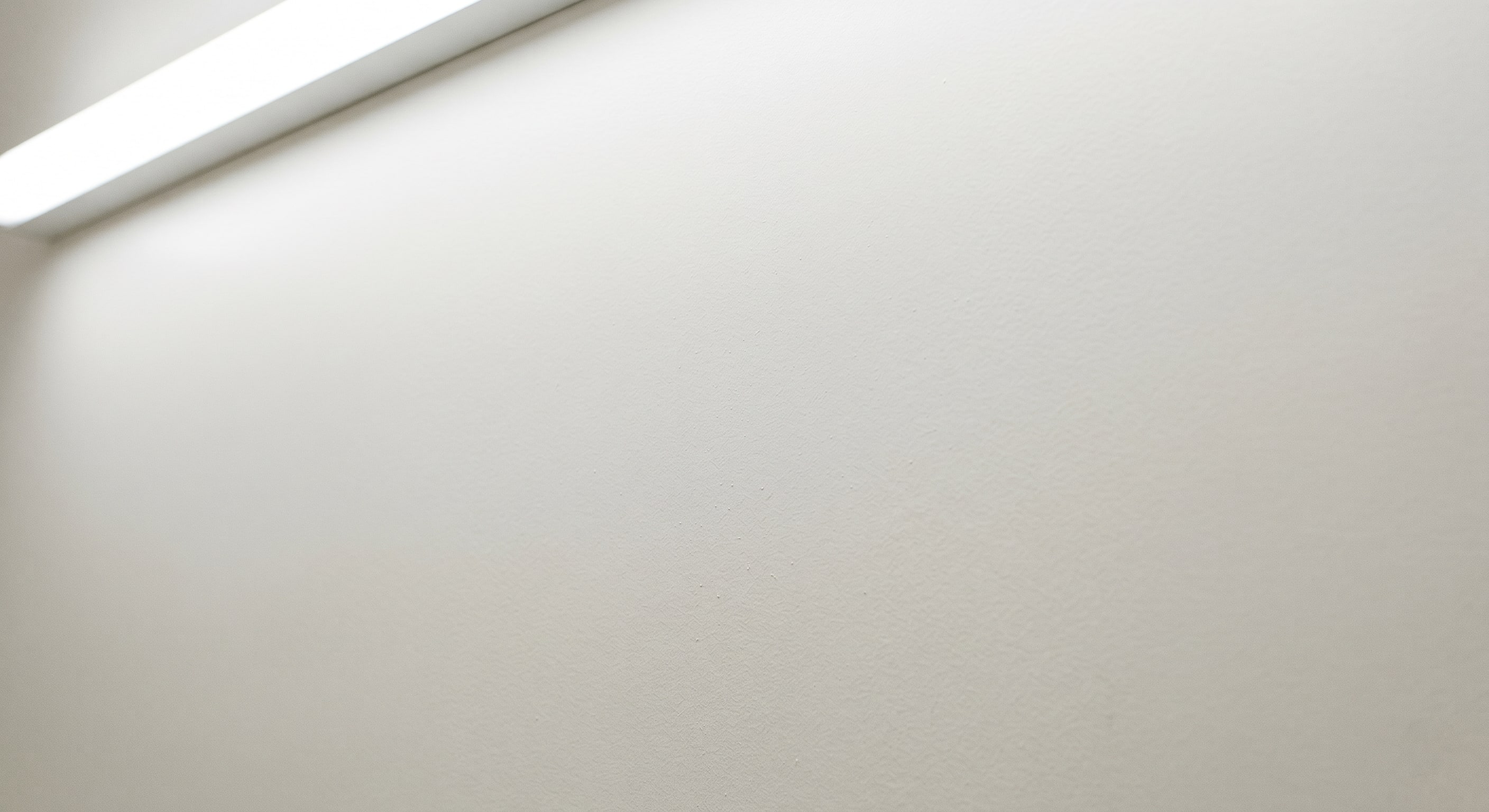 Completed airless spray coatings in an empty commercial warehouse interior aisle