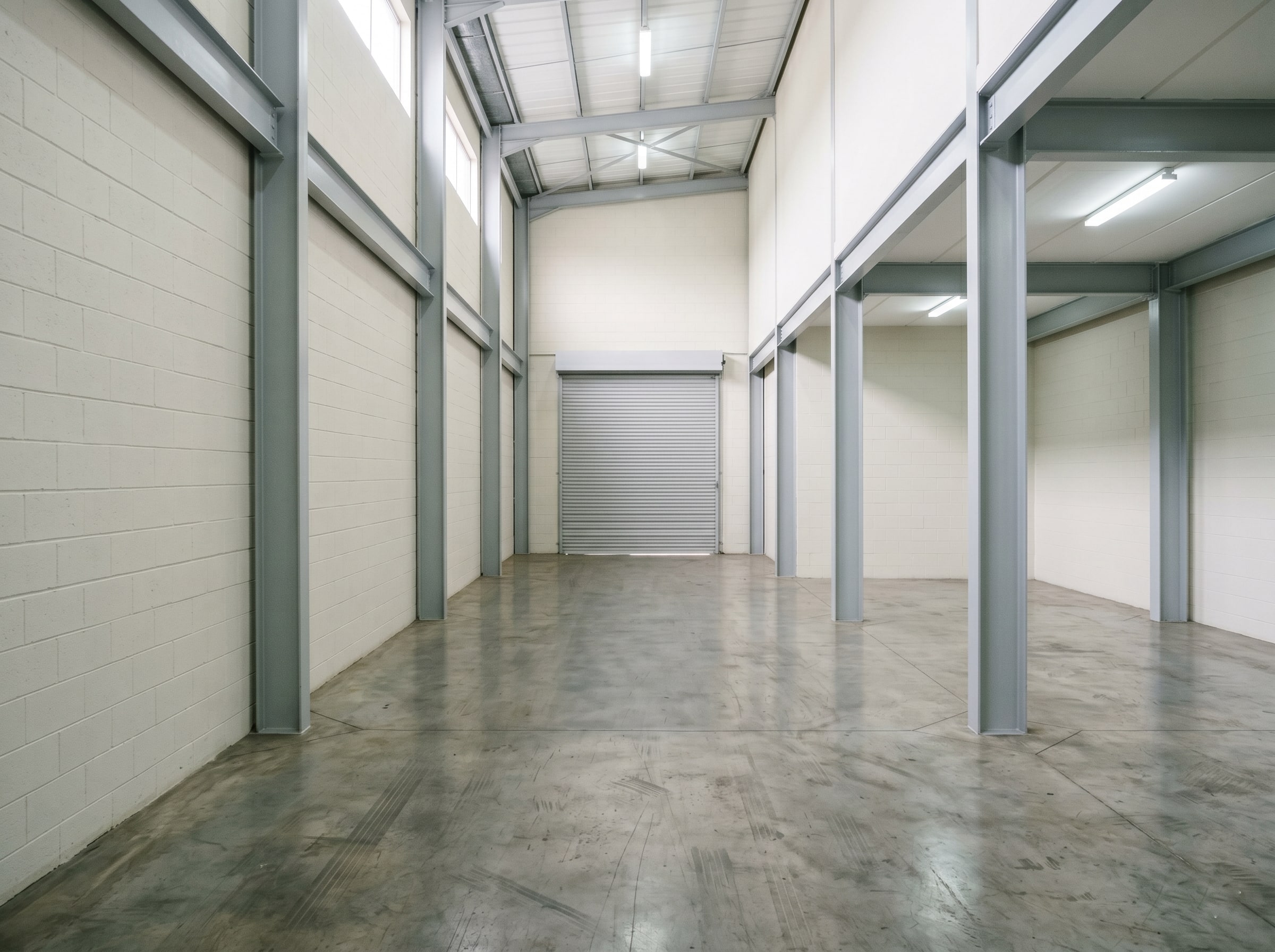 Completed logistics hall interior repaint with refreshed walls and columns in Isando