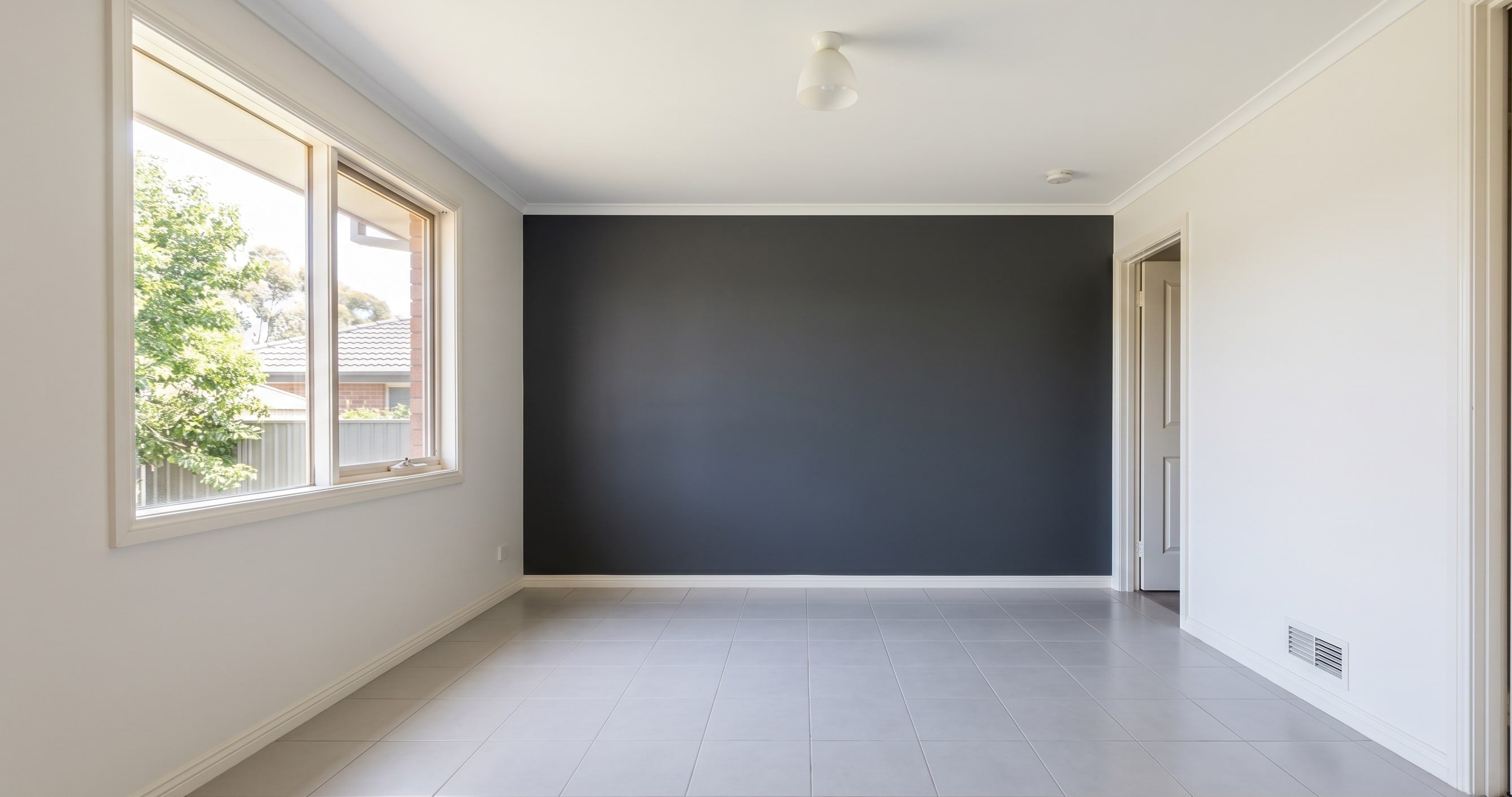 Close-up of completed internal wall and door architrave coating junction