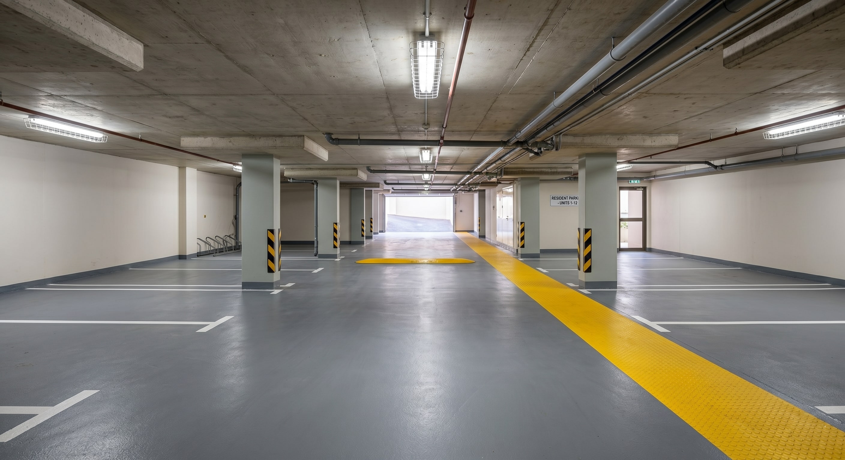Close-up of a completed white parking line on asphalt at a Gauteng complex