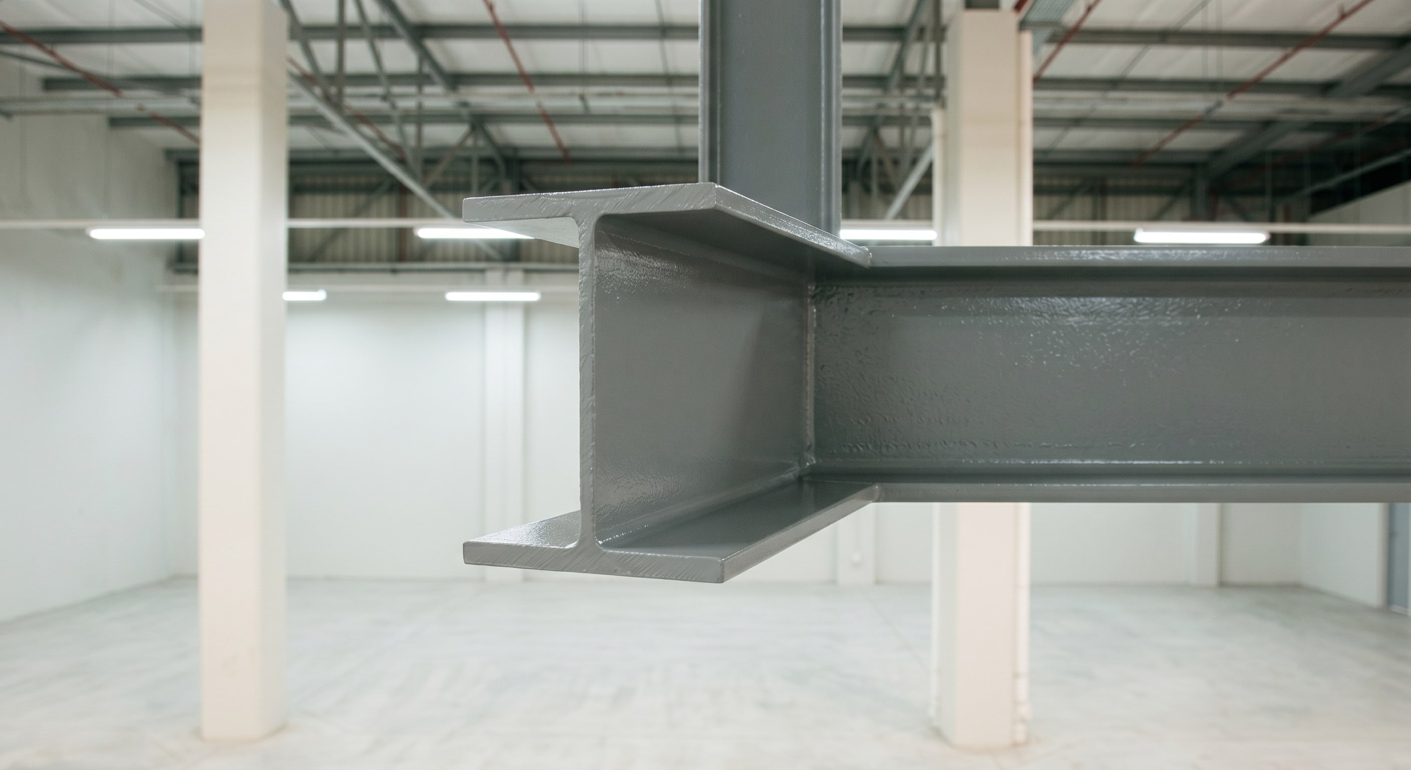 Close-up of completed coating junction between warehouse block wall and steel column