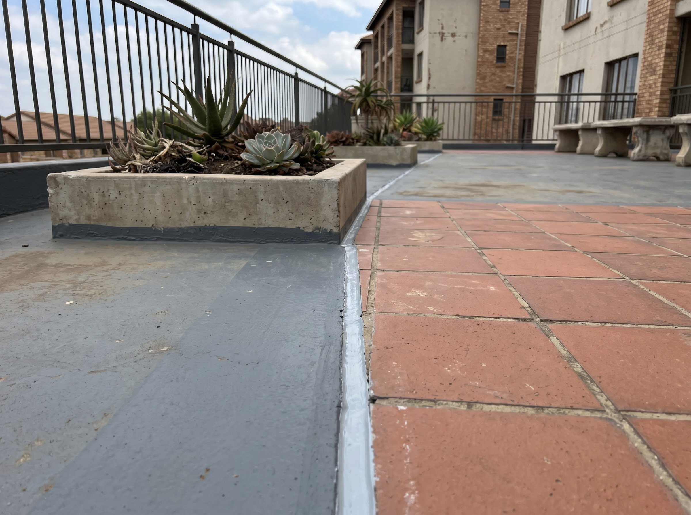 Renewed expansion joint at a sectional-title podium walkway edge